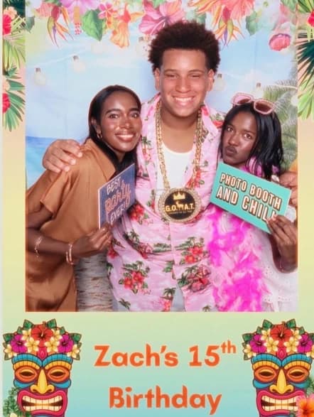 Three guests posing with props at Zach’s luau birthday